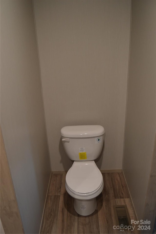 bathroom with wood-type flooring and toilet