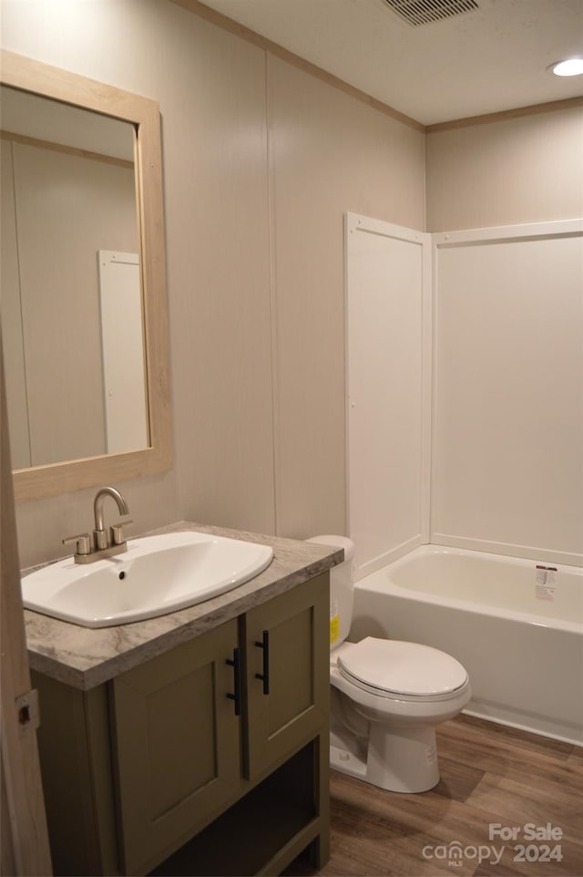 bathroom featuring hardwood / wood-style floors, vanity, and toilet