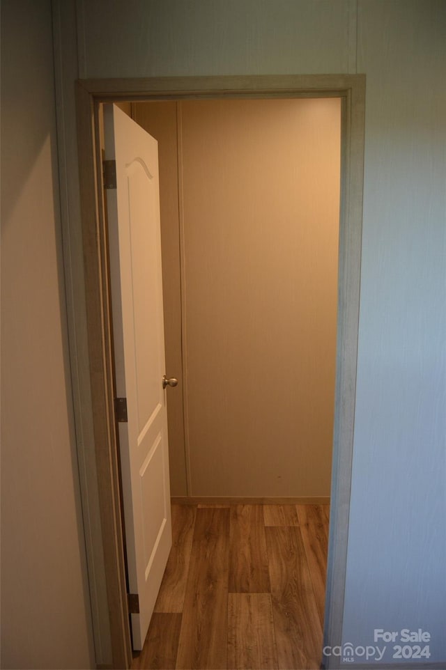 hallway with wood-type flooring