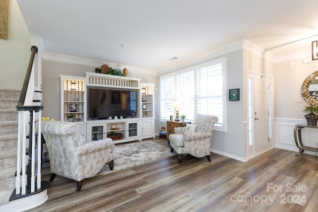 living room featuring wood-type flooring and crown molding