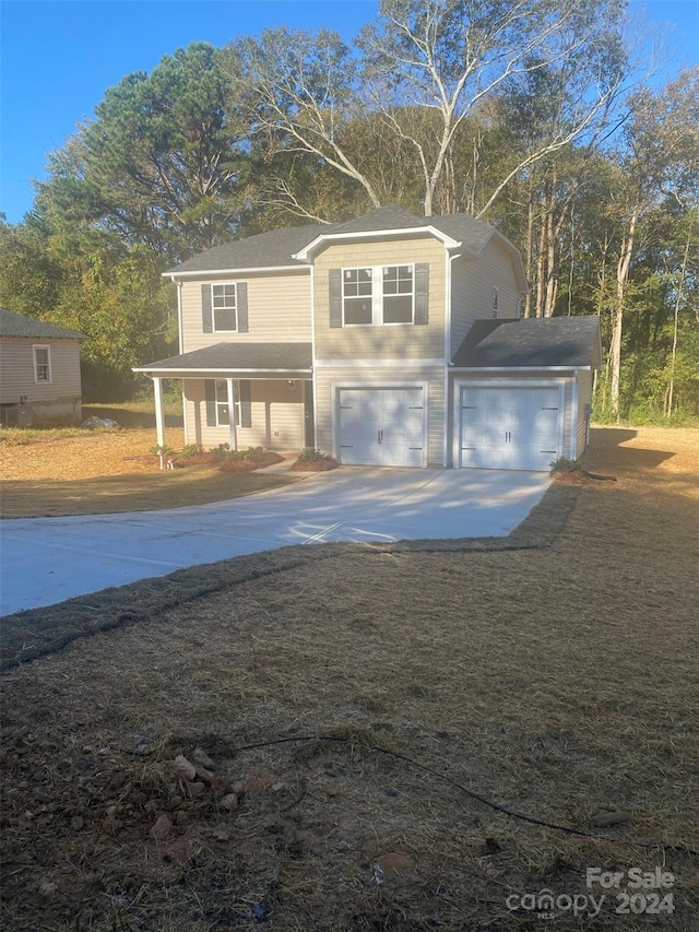 view of front facade with a porch and a garage