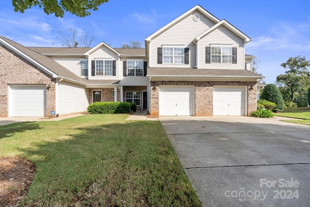 front facade with a front lawn and a garage