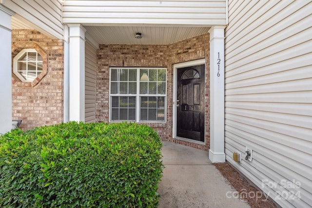 view of exterior entry with a porch