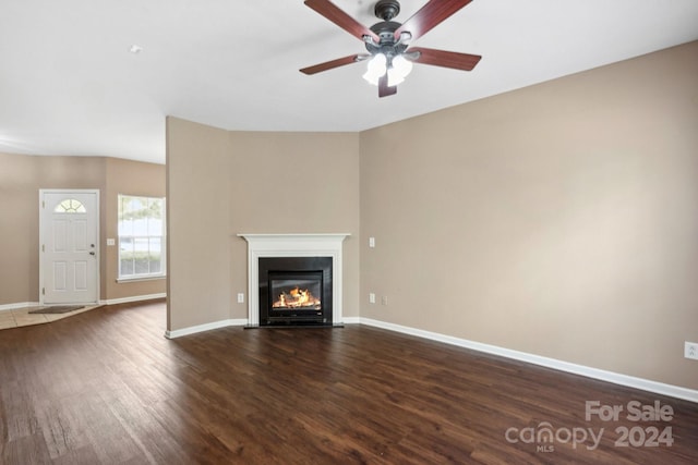 unfurnished living room featuring ceiling fan and dark hardwood / wood-style flooring