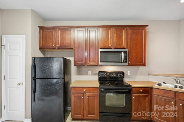 kitchen with sink and black appliances