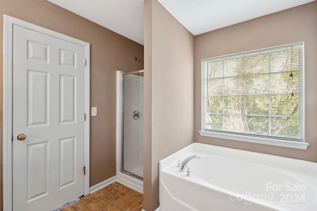 bathroom with shower with separate bathtub