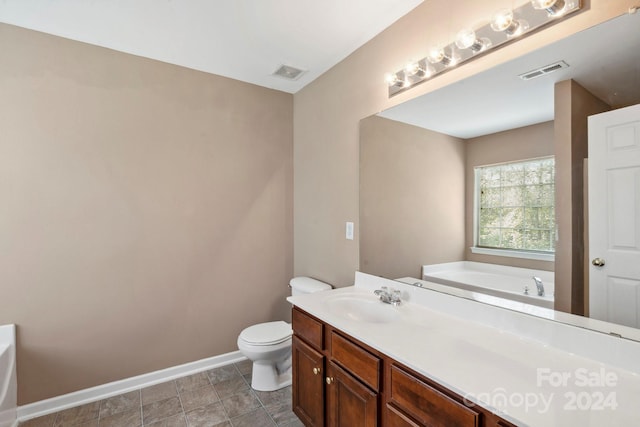 bathroom featuring a bath, vanity, and toilet