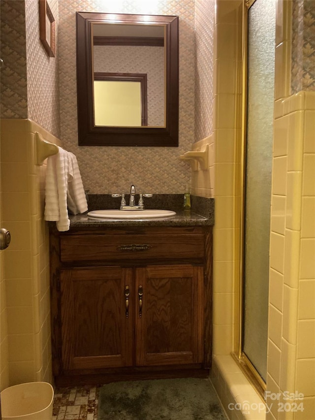 bathroom featuring vanity and an enclosed shower