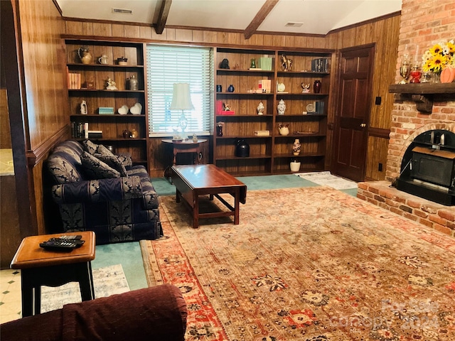 living area featuring ornamental molding, vaulted ceiling with beams, and wooden walls