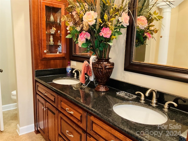 bathroom featuring tile patterned floors, vanity, and toilet