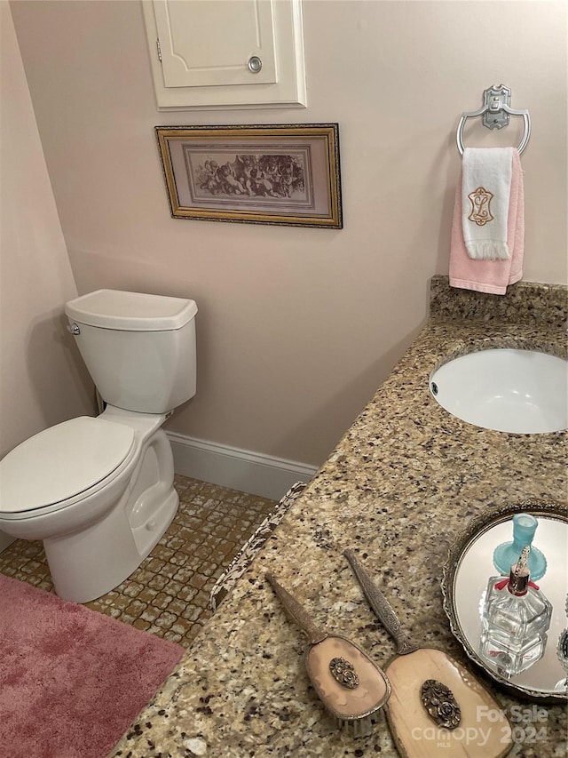 bathroom featuring tile patterned flooring, toilet, and sink