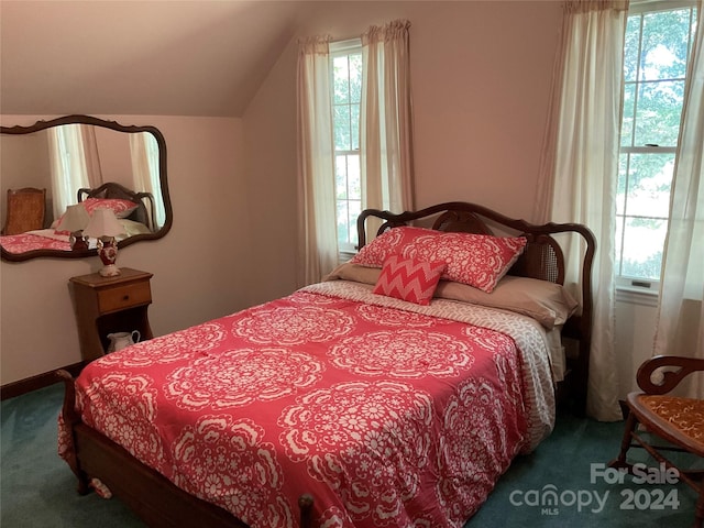 bedroom with dark carpet and vaulted ceiling