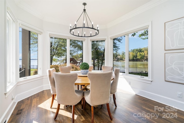 sunroom featuring a water view, a notable chandelier, and a healthy amount of sunlight