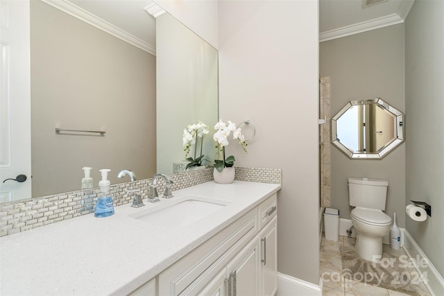 bathroom with vanity, toilet, crown molding, and tasteful backsplash