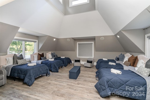 bedroom with light hardwood / wood-style flooring and vaulted ceiling