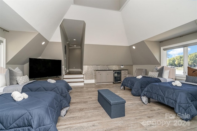 bedroom featuring beverage cooler and light hardwood / wood-style flooring