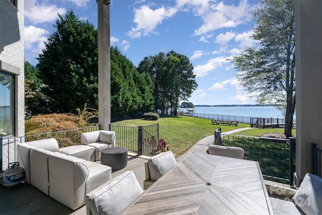 view of patio / terrace with a water view and an outdoor living space