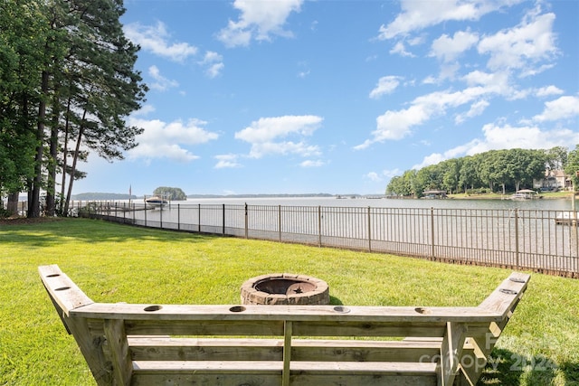 view of yard featuring a water view and a fire pit