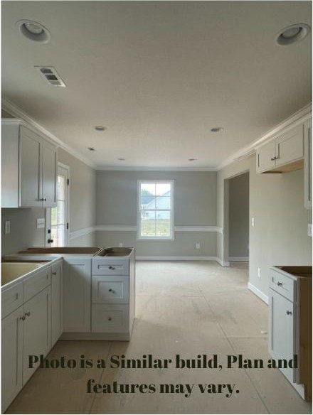 kitchen with crown molding and white cabinets