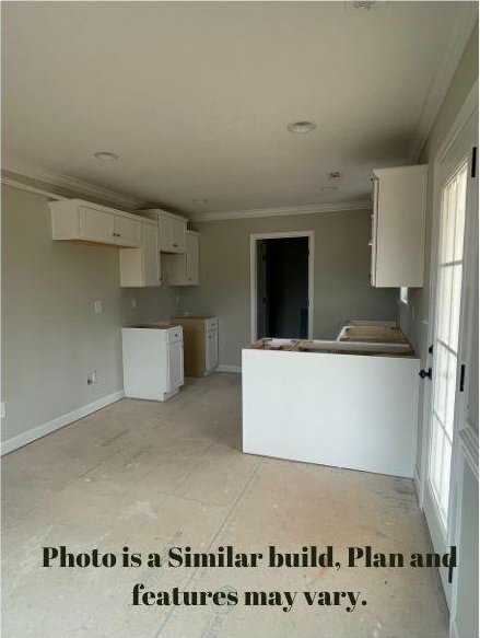 kitchen featuring white cabinetry and crown molding