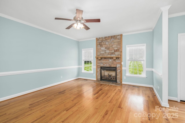 unfurnished living room featuring a fireplace, plenty of natural light, light hardwood / wood-style floors, and ornamental molding