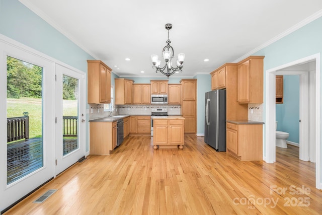 kitchen with sink, light brown cabinets, stainless steel appliances, light hardwood / wood-style floors, and decorative backsplash