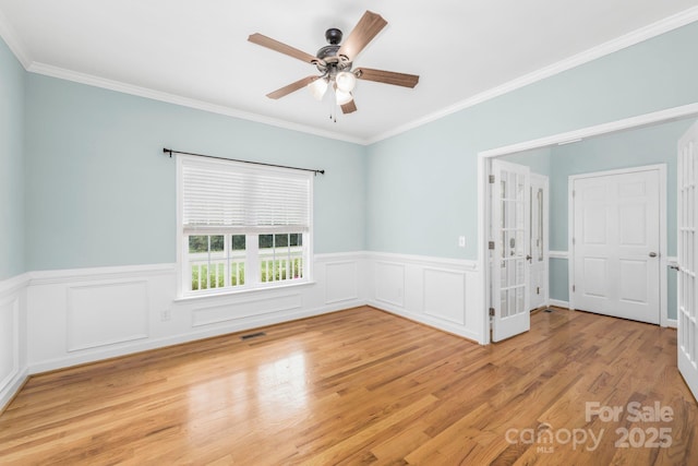 unfurnished room with crown molding, ceiling fan, and light hardwood / wood-style floors