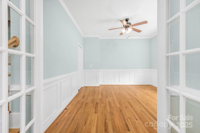 empty room featuring ornamental molding, ceiling fan, and light hardwood / wood-style floors