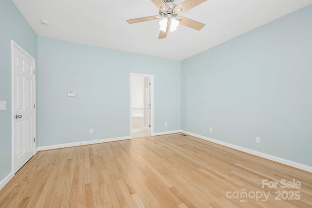 spare room featuring ceiling fan and light hardwood / wood-style flooring