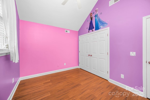 unfurnished bedroom with ceiling fan, wood-type flooring, and vaulted ceiling