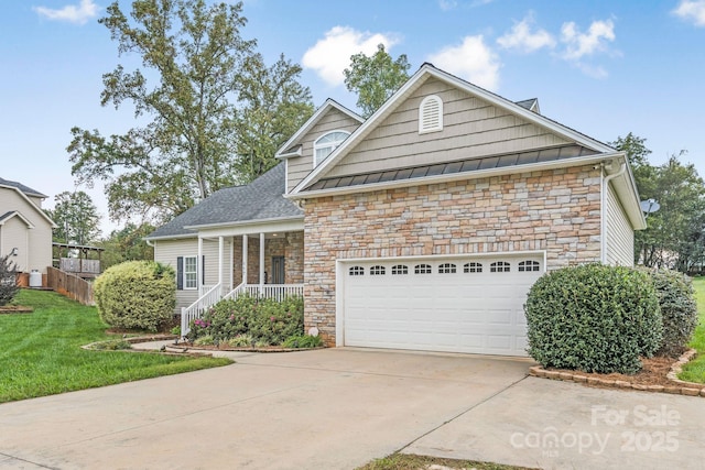 view of front of home featuring a garage, a front lawn, and a porch