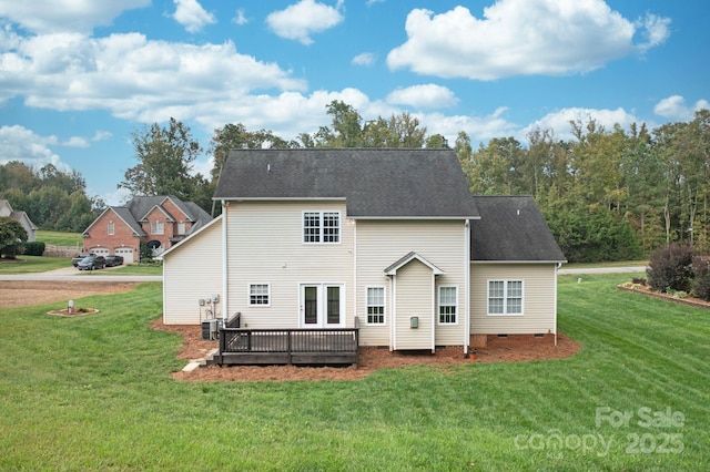 rear view of property featuring central AC, a deck, and a lawn