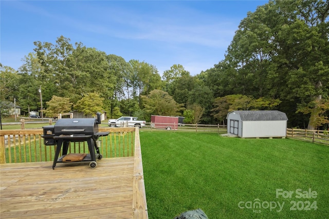 view of yard featuring a deck and a storage unit