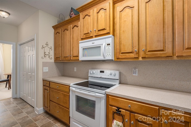 kitchen with tasteful backsplash and white appliances