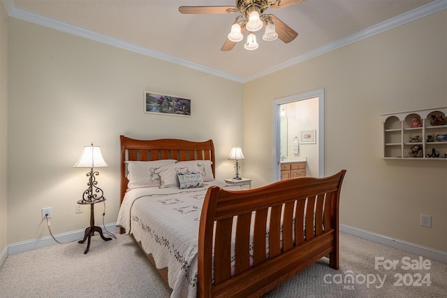 carpeted bedroom featuring ornamental molding, ensuite bathroom, and ceiling fan