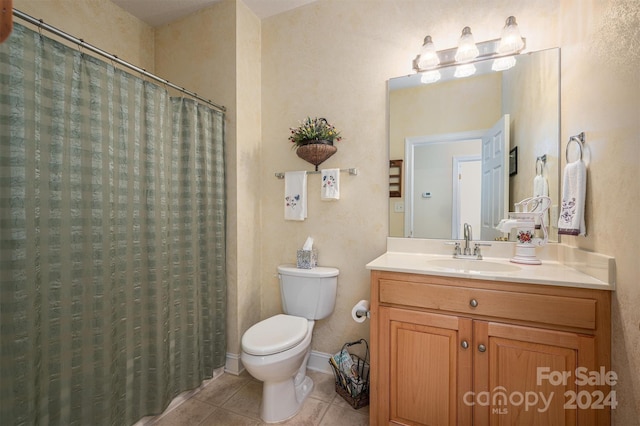 bathroom featuring tile patterned floors, a shower with shower curtain, vanity, and toilet