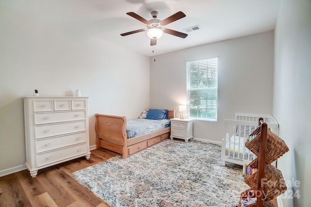 bedroom with wood-type flooring and ceiling fan