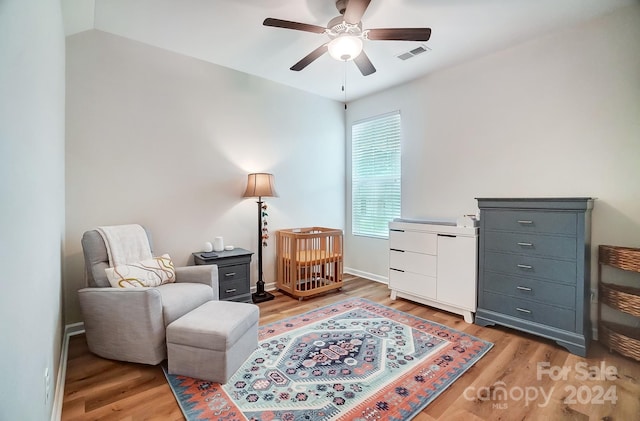 sitting room with wood-type flooring and ceiling fan