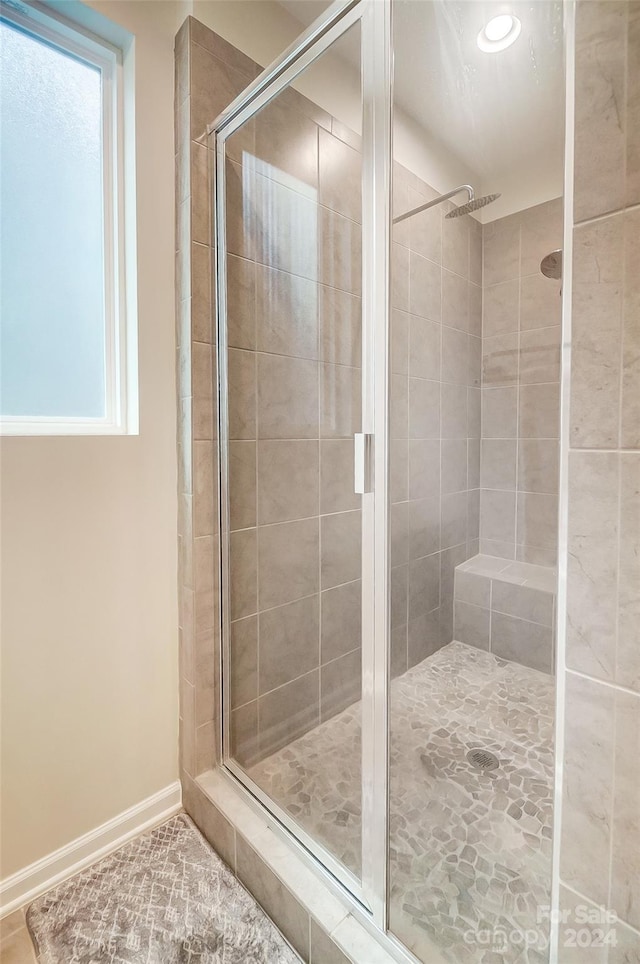 bathroom featuring walk in shower and plenty of natural light