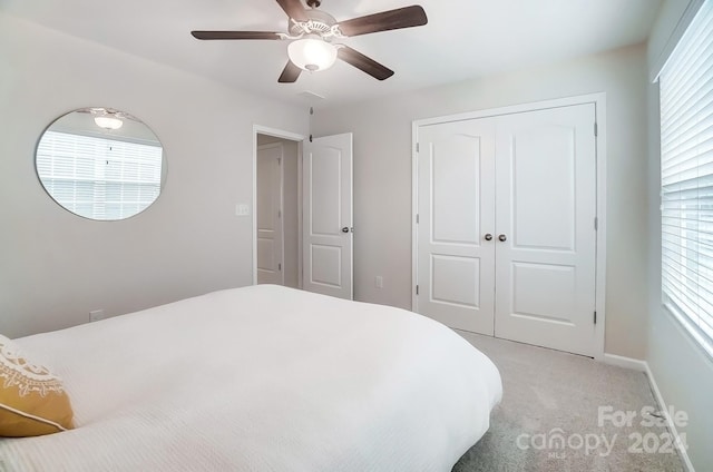 bedroom with light carpet, a closet, and ceiling fan