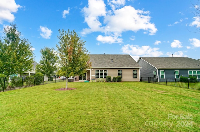 back of property featuring a yard