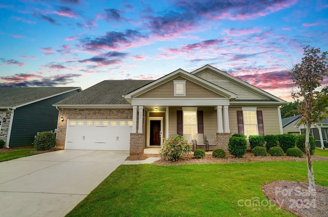 craftsman-style house featuring a lawn, a porch, and a garage