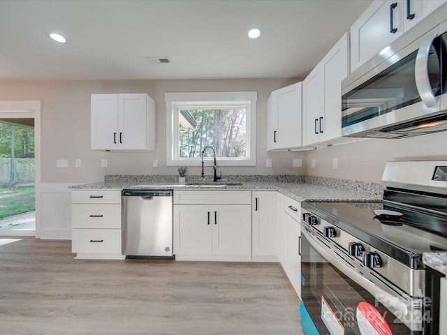 40 Ridgecrest Ave, Peachland, NC 28133 - kitchen featuring stainless steel appliances, light stone counters, recessed lighting, light wood-type flooring, and white cabinetry