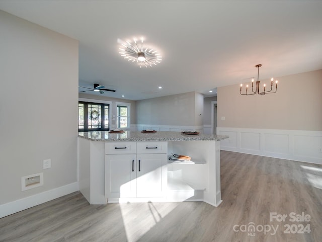 40 Ridgecrest Ave, Peachland, NC 28133 - kitchen with a chandelier, light wood-style flooring, white cabinetry, and light stone countertops