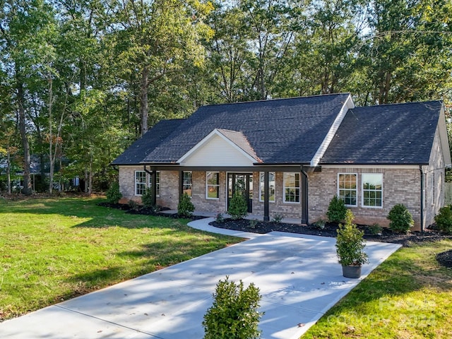 40 Ridgecrest Ave, Peachland, NC 28133 - view of front of house featuring a shingled roof, a front lawn, and brick siding