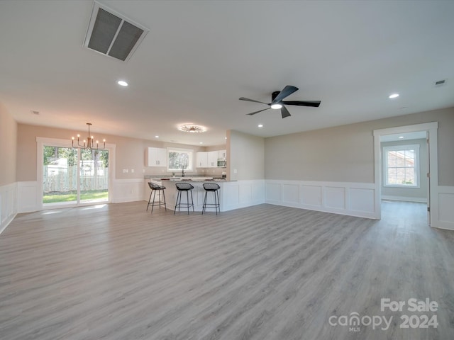 40 Ridgecrest Ave, Peachland, NC 28133 - living room featuring a decorative wall, a chandelier, light wood-style flooring, a wainscoted wall, and recessed lighting