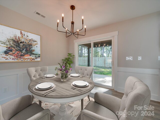 40 Ridgecrest Ave, Peachland, NC 28133 - dining area with a chandelier, wood finished floors, a wainscoted wall, and a decorative wall