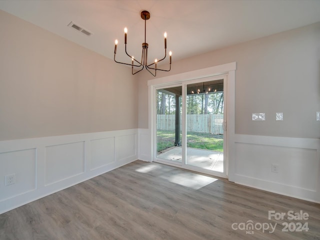40 Ridgecrest Ave, Peachland, NC 28133 - unfurnished dining area featuring a chandelier, a decorative wall, wainscoting, and wood finished floors