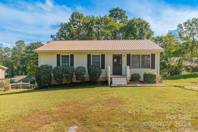 ranch-style home with a front lawn