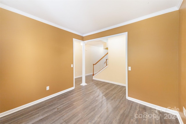 unfurnished room featuring wood-type flooring and ornamental molding